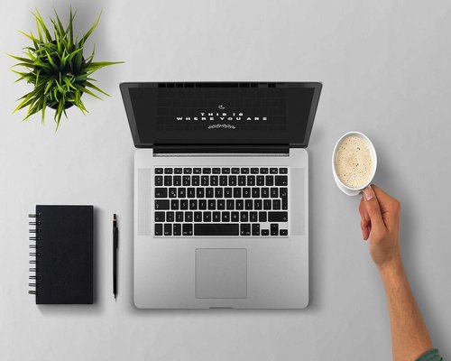 Professional stretching arms while working at desk