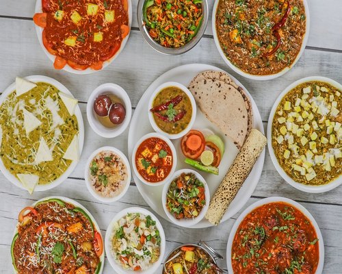 Bowl of yellow dal with fresh roti and salad