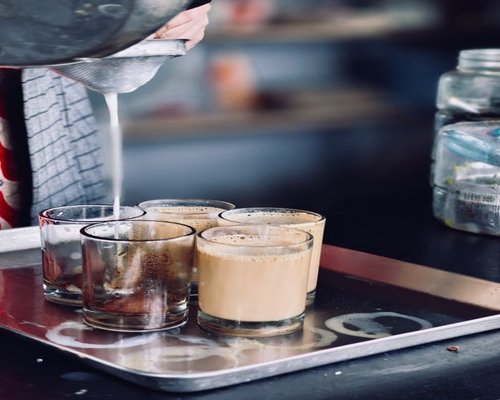 A cup of Indian masala chai being poured