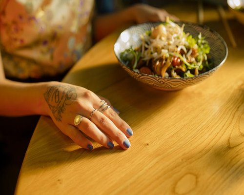 Person eating mindfully at a wooden dining table